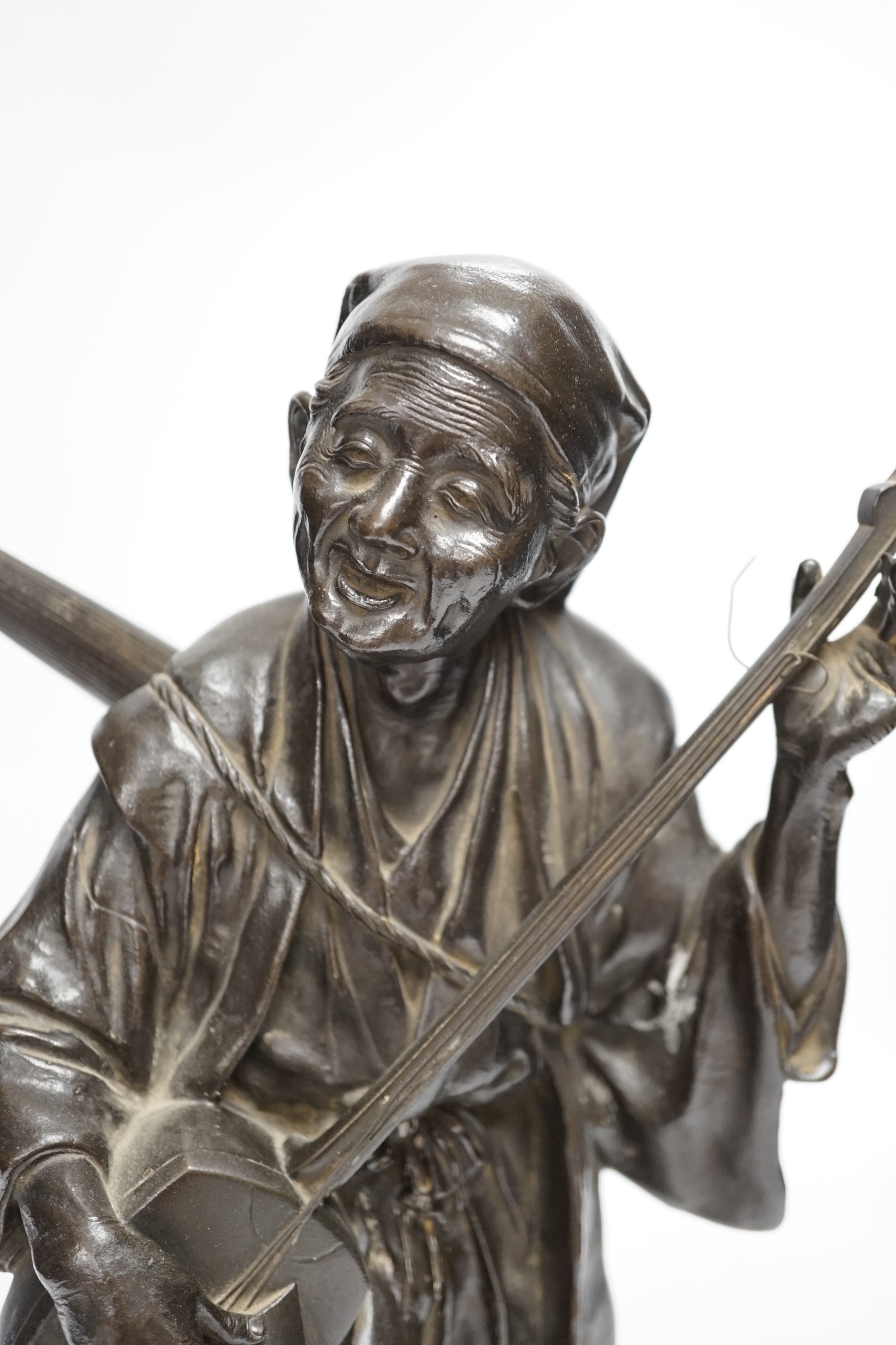 A Japanese bronze figure of a musician, Meiji period, signed, 37cm high. Condition - good